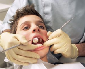 Close-up of boy having teeth examined